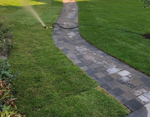 Blockwork pathway through new lawn.