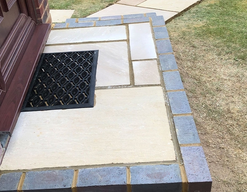 Blockwork and paved doorstep.