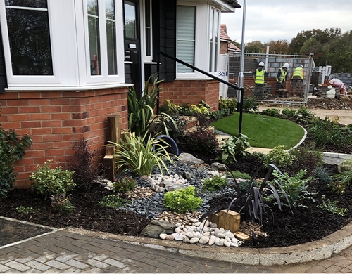 Raised front garden landscaped with high spec features.