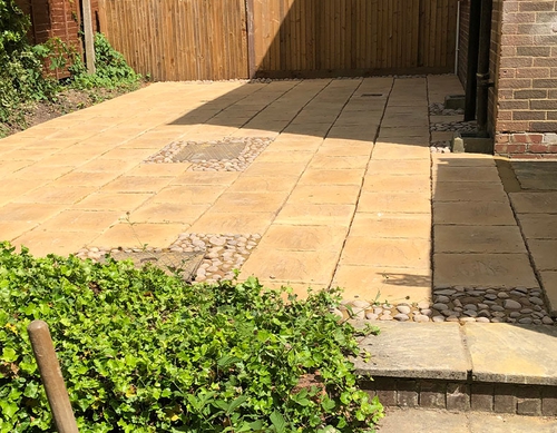 Raised paved patio with stonework features.