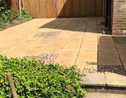 High level paved garden with stone surround features.